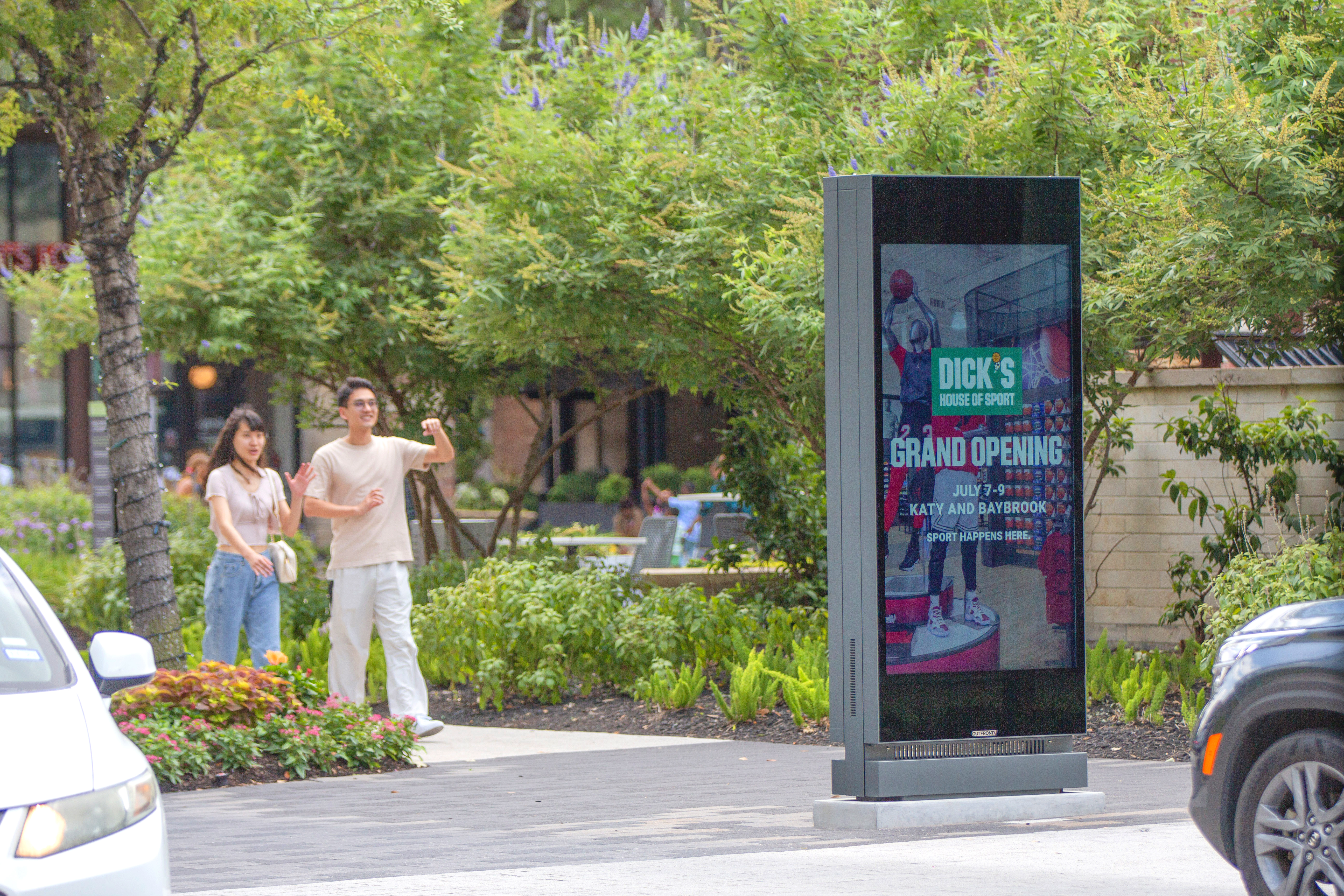 two-pedestrians-looking-at-placard-75-houston-city-centre.jpg