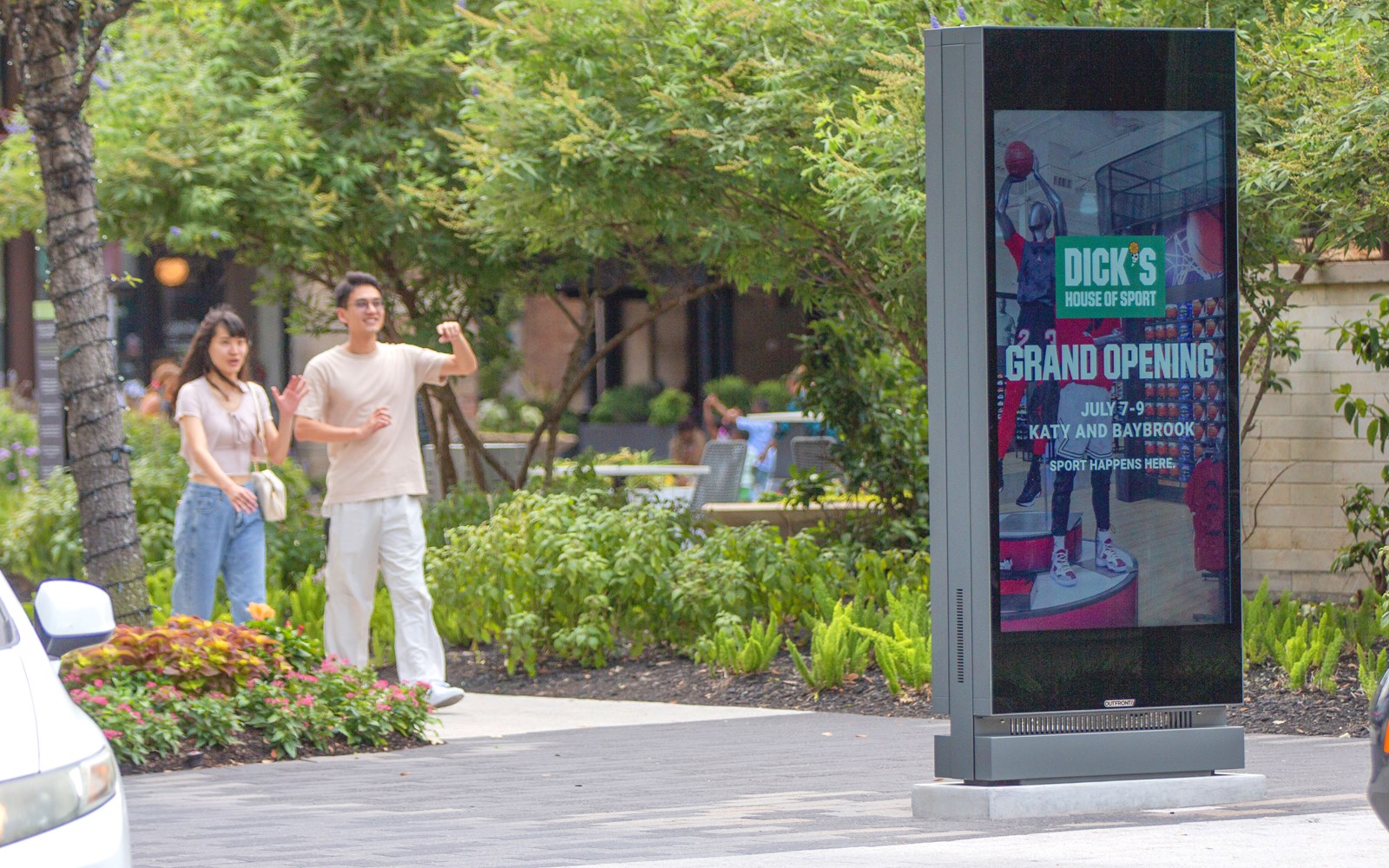 two-pedestrians-looking-at-placard-75-houston-city-centre.jpg