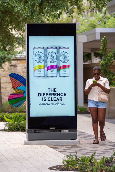 Young woman walking past a Placard 75 Houston CityCentre.jpg