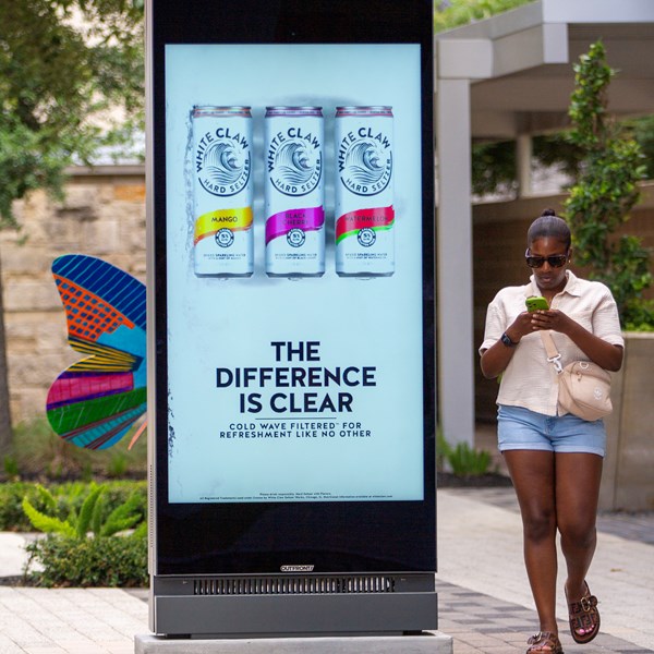 Young woman walking past a Placard 75 Houston CityCentre.jpg